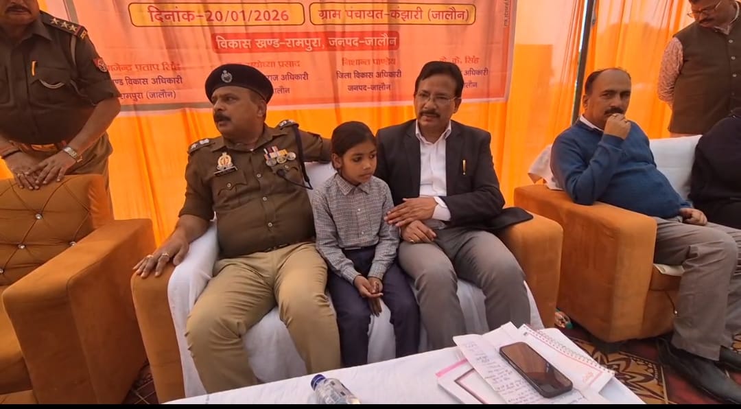 जालौन के जिलाधिकारी राजेश कुमार पाण्डेय और एसपी डॉ. दुर्गेश कुमार जन चौपाल के दौरान मासूम राधिका को मंच पर अपने पास बैठाकर दुलारते हुए