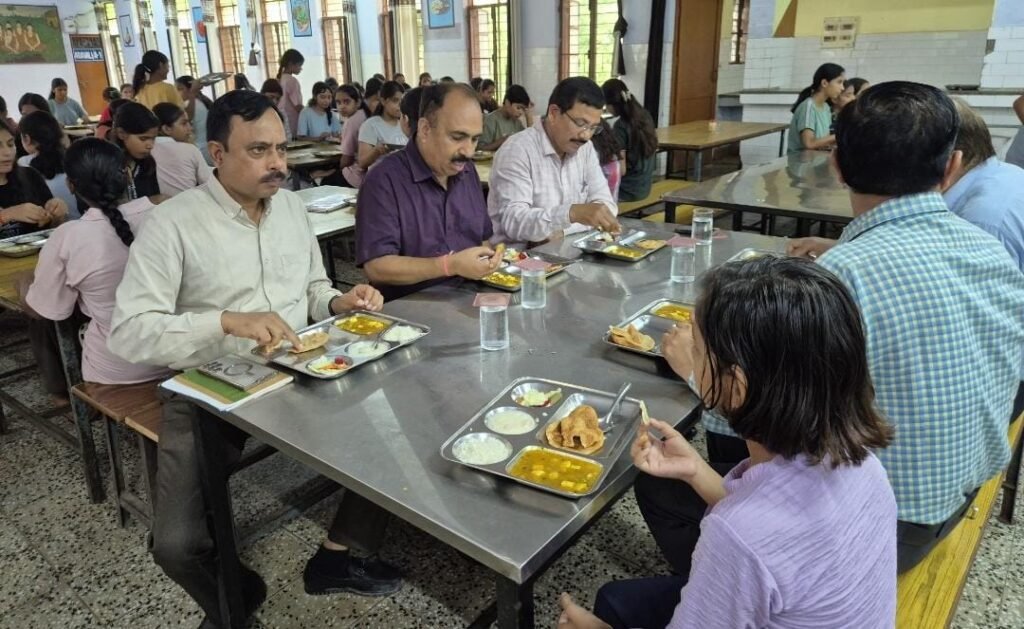 जालौन के जवाहर नवोदय विद्यालय में जिलाधिकारी राजेश कुमार पाण्डेय बच्चों के बीच बैठकर उनके साथ भोजन करते हुए और भोजन की गुणवत्ता का निरीक्षण करते हुए।